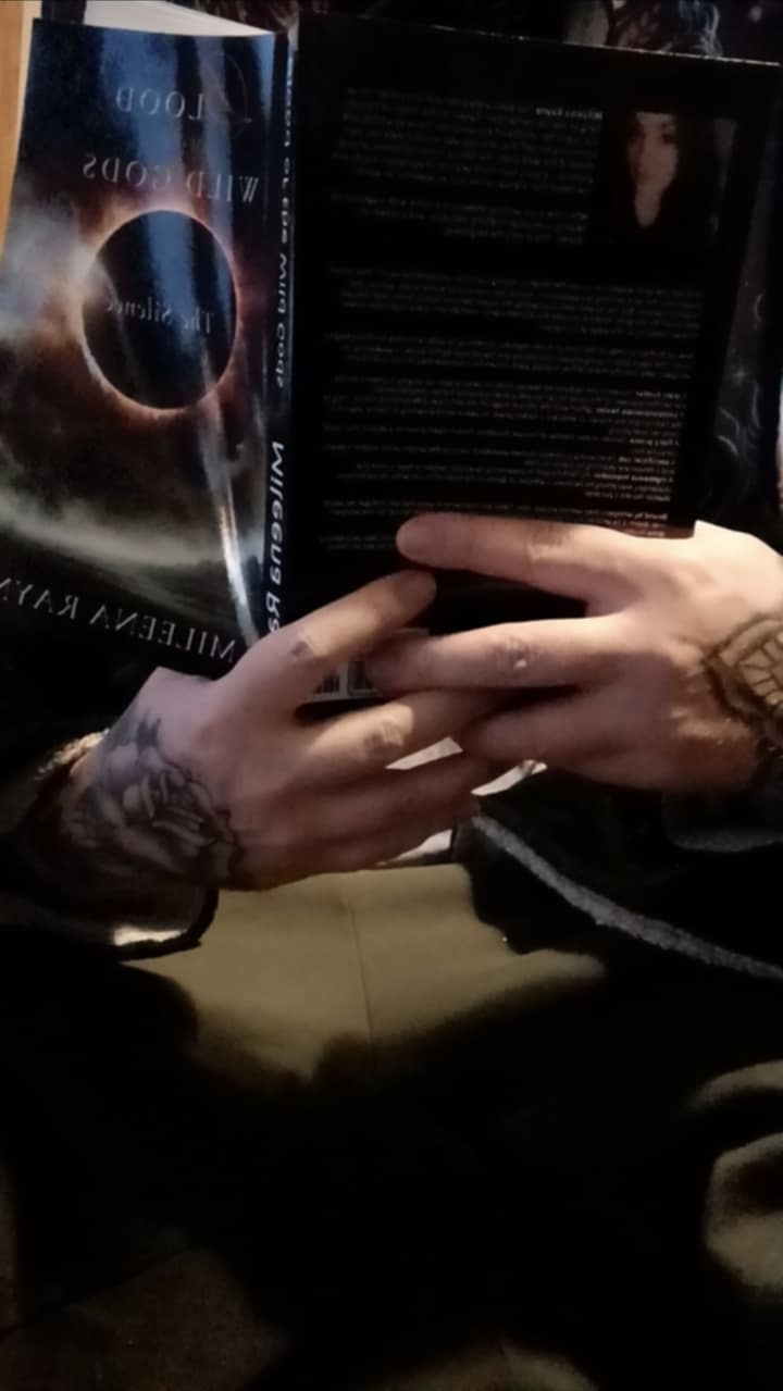 Friend holding Blood of the Wild Gods book